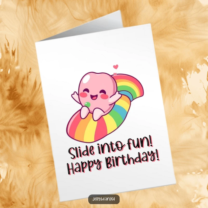 Funny Free Printable Birthday Card featuring a gleeful jelly bean character joyfully sliding down a vibrant rainbow.