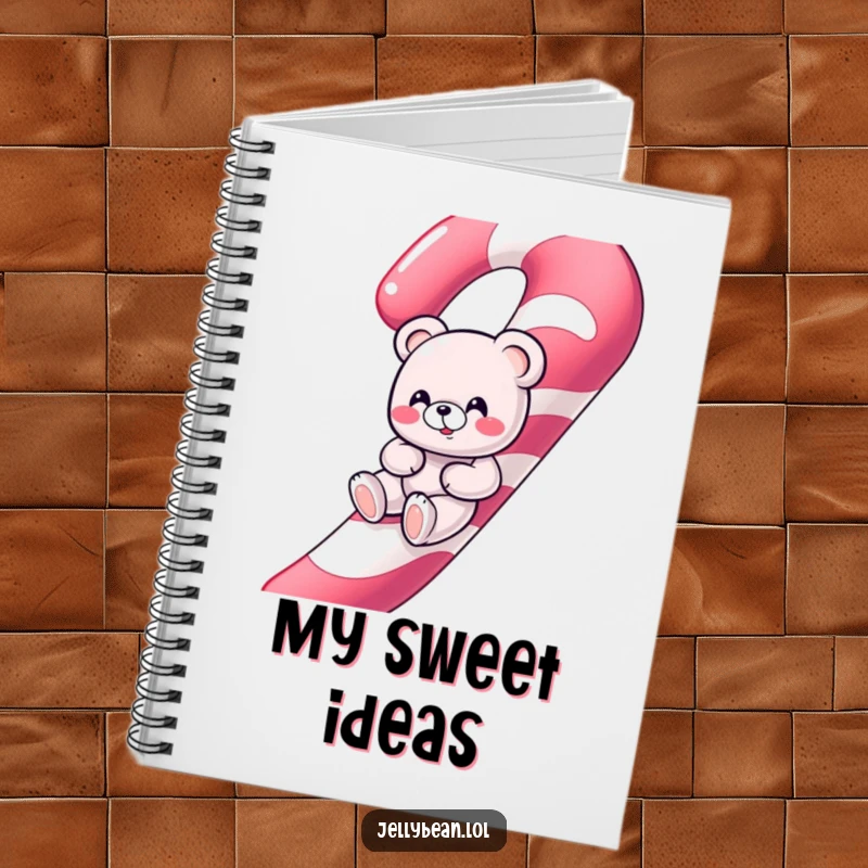 Funny giggling gummy bear character sliding down a giant candy cane on the cover of a fun notebook.